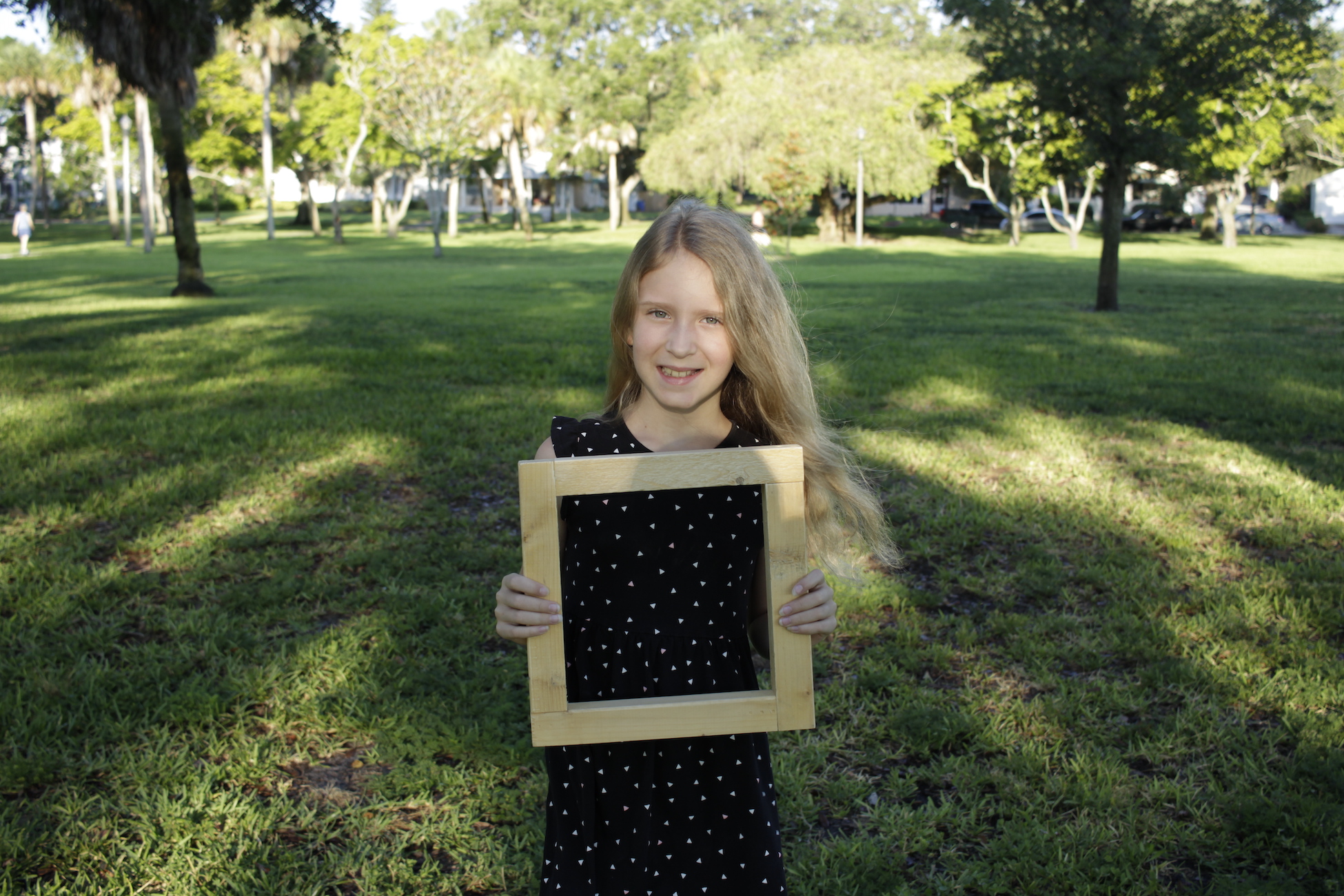 Photograph of girl with square foot. 