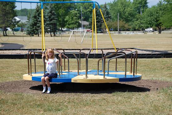 Image of a person on a circular merry-go-round.